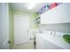 Functional laundry room with cabinets, sink, and modern washer/dryer at 7475 Se 105Th Pl, Belleview, FL 34420