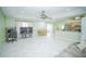 Open-concept living area with tile flooring, vaulted ceilings, and seamless flow to kitchen and dining at 7475 Se 105Th Pl, Belleview, FL 34420