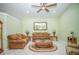 Cozy living room with comfortable seating, ceiling fan, and neutral decor at 7475 Se 105Th Pl, Belleview, FL 34420
