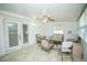 Bright sunroom featuring tile floors, wicker seating, ceiling fan, and lots of natural light at 7475 Se 105Th Pl, Belleview, FL 34420