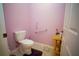 Powder room with toilet and a small wooden side table next to the door at 7475 Se 105Th Pl, Belleview, FL 34420