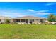 Lush backyard with a screened-in lanai, offering a private and serene outdoor space at 8111 Sw 95Th Ct, Ocala, FL 34481