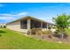 A screened-in lanai overlooking a well-maintained backyard with lush landscaping at 8111 Sw 95Th Ct, Ocala, FL 34481