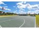 A full outdoor basketball court complete with flags and covered picnic tables for fun and recreation at 8111 Sw 95Th Ct, Ocala, FL 34481