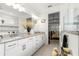 Bright bathroom showcasing double sink vanity, granite countertops, and access to shower and bedroom at 8111 Sw 95Th Ct, Ocala, FL 34481