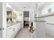 Bright bathroom with double sink vanity, granite countertops, glass shower and open view to the bedroom at 8111 Sw 95Th Ct, Ocala, FL 34481