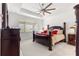 Primary bedroom with tray ceiling, ceiling fan, and large bed at 8111 Sw 95Th Ct, Ocala, FL 34481