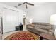 Cozy bedroom featuring a ceiling fan, comfortable seating, and ample closet space at 8111 Sw 95Th Ct, Ocala, FL 34481