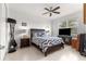 Cozy bedroom with ceiling fan, tiled floor, TV, and a comfortable bed with blue and white bedding at 8111 Sw 95Th Ct, Ocala, FL 34481
