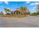 Beautiful clubhouse with palm trees, colorful flowers, and well-maintained landscaping at 8111 Sw 95Th Ct, Ocala, FL 34481