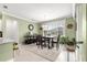 Bright dining area featuring a chandelier, a large window, and a view of the backyard at 8111 Sw 95Th Ct, Ocala, FL 34481