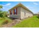 Exterior shot of the side of the home featuring red shutters and a lush green lawn at 8111 Sw 95Th Ct, Ocala, FL 34481