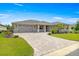 Charming single-story home with a well-manicured lawn, red shutters, and a brick-paved driveway at 8111 Sw 95Th Ct, Ocala, FL 34481