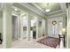 Inviting foyer featuring a tiled floor, a decorative rug, and an adjacent bar area with a wine cooler at 8111 Sw 95Th Ct, Ocala, FL 34481