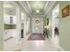 Inviting foyer featuring a tiled floor, a decorative rug, and an adjacent bar area with a wine cooler at 8111 Sw 95Th Ct, Ocala, FL 34481