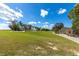 A well-manicured golf course with a clubhouse in the background offers a serene and picturesque setting at 8111 Sw 95Th Ct, Ocala, FL 34481