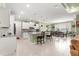 Open-concept kitchen and dining area featuring white cabinets, granite countertops, and stainless steel appliances at 8111 Sw 95Th Ct, Ocala, FL 34481