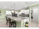 Bright kitchen features an island with granite countertops and pendant lighting at 8111 Sw 95Th Ct, Ocala, FL 34481