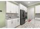 Bright kitchen featuring stainless steel appliances, granite countertops and white cabinetry at 8111 Sw 95Th Ct, Ocala, FL 34481