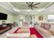 Comfortable living room with a ceiling fan and an open view of the foyer, bar area, and kitchen at 8111 Sw 95Th Ct, Ocala, FL 34481