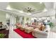 Open-concept living room with a ceiling fan and an open view of the foyer, bar area, and kitchen at 8111 Sw 95Th Ct, Ocala, FL 34481