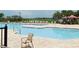 A large outdoor pool with comfortable lounge chairs offers a relaxing place to enjoy the outdoors at 8111 Sw 95Th Ct, Ocala, FL 34481