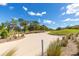 Scenic golf course view of a sand trap with surrounding grass and trees on a sunny day at 8111 Sw 95Th Ct, Ocala, FL 34481