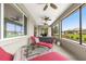 Relaxing screened-in porch featuring comfortable lounge chairs, ceiling fans, and serene outdoor views at 8111 Sw 95Th Ct, Ocala, FL 34481