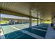 A covered outdoor shuffleboard court offers ample space and shelter for recreational activities at 8111 Sw 95Th Ct, Ocala, FL 34481