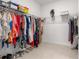 Organized walk-in closet features shelving for shoes, handbags, and hanging rods for clothes at 8111 Sw 95Th Ct, Ocala, FL 34481