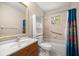 Well-lit bathroom featuring a shower-tub combo, vanity with sink, and storage shelves for personal items at 8449 Sw 105Th Pl, Ocala, FL 34481