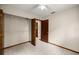 Neutral bedroom showcasing a closet, ceiling fan, and an open doorway at 8449 Sw 105Th Pl, Ocala, FL 34481