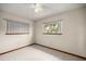 Bright bedroom featuring two windows with blinds and tile flooring at 8449 Sw 105Th Pl, Ocala, FL 34481