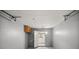 Spacious garage featuring an open doorway and a cabinet at 8449 Sw 105Th Pl, Ocala, FL 34481