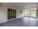 Covered screened patio with exterior lighting and large sliding glass doors at 8449 Sw 105Th Pl, Ocala, FL 34481