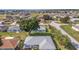 This aerial shot displays the home nestled in a quiet neighborhood with mature trees at 8722 Sw 60Th Cir, Ocala, FL 34476