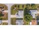 An aerial view shows a well-maintained home with manicured landscaping and a classic roof design at 8722 Sw 60Th Cir, Ocala, FL 34476