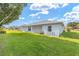 Well-maintained backyard featuring lush green grass, screened-in patio, and serene surroundings at 8722 Sw 60Th Cir, Ocala, FL 34476