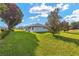 Lush green backyard featuring a well-manicured lawn, mature trees, and beautiful landscaping at 8722 Sw 60Th Cir, Ocala, FL 34476