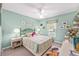 Cozy bedroom with pastel-colored walls, carpet flooring, a ceiling fan, and a comfortable bed at 8722 Sw 60Th Cir, Ocala, FL 34476