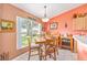 Dining area features tile floor, light walls, multiple windows and a wooden dining table at 8722 Sw 60Th Cir, Ocala, FL 34476