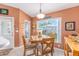 Dining area features tile floor, windows with a backyard view and wooden furniture at 8722 Sw 60Th Cir, Ocala, FL 34476