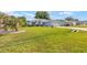 Well-maintained single-story home showcasing a lush green lawn and mature landscaping at 8722 Sw 60Th Cir, Ocala, FL 34476