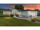 Charming single-story home at sunset featuring a well-manicured lawn and light blue exterior at 8722 Sw 60Th Cir, Ocala, FL 34476