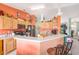The kitchen shows tile floors, light wood cabinets, black appliances, and an open bar at 8722 Sw 60Th Cir, Ocala, FL 34476