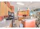 The kitchen offers tile floors, light wood cabinets, black appliances, and an open breakfast bar at 8722 Sw 60Th Cir, Ocala, FL 34476
