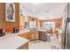 The kitchen features tile floors, tile backsplash, window over sink, with view into dining area at 8722 Sw 60Th Cir, Ocala, FL 34476