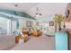 Comfortable living room with neutral carpeting, ceiling fan, and bright natural light at 8722 Sw 60Th Cir, Ocala, FL 34476