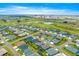 An aerial view showcases a single-Gathering home close to a golf course, ponds, and neighboring communities at 907 Trifu Ter, The Villages, FL 32163