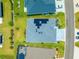 Aerial view of a home showing the roof, solar panels, landscaping, and driveway at 907 Trifu Ter, The Villages, FL 32163